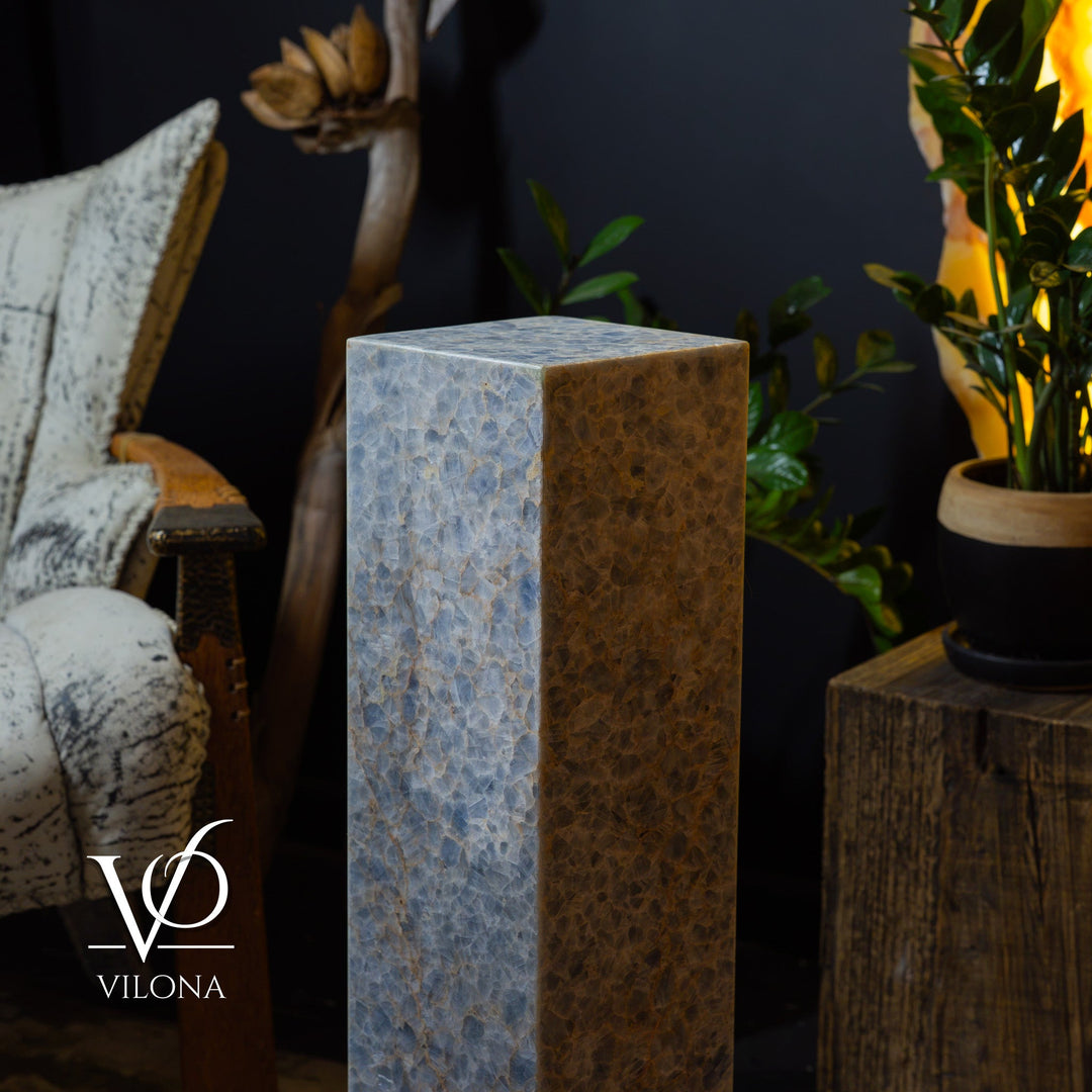 Small square floor lamp with blue marbled stone body and visible warm internal glow.