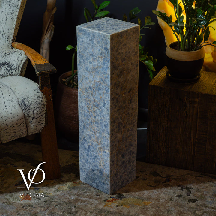 Square small floor lamp with blue marbled onyx-style body and warm light emitting.