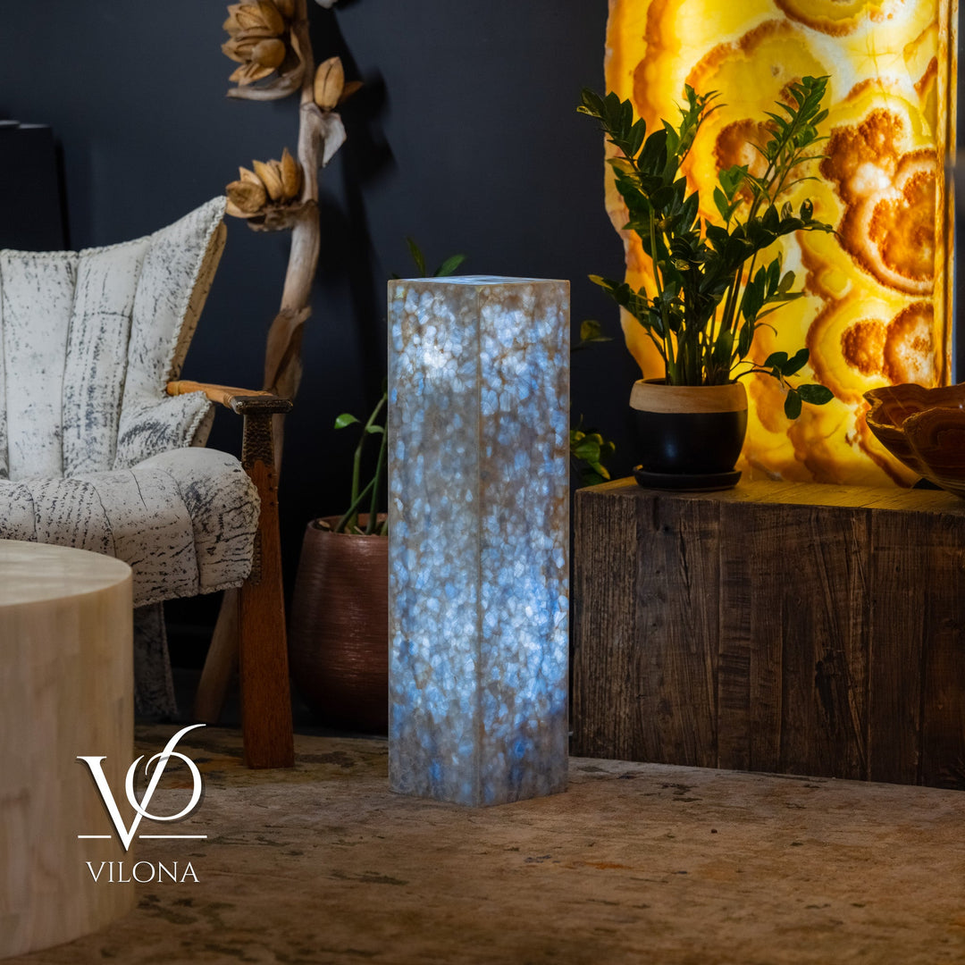 Blue square column floor lamp with bright interior glow through textured panels.