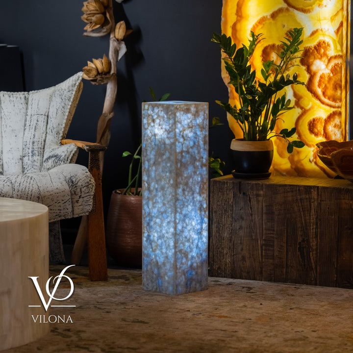 Blue square column floor lamp with bright interior glow through textured panels.