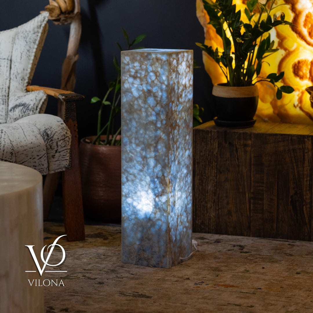 Blue square column floor lamp with soft glow visible through patterned surface.