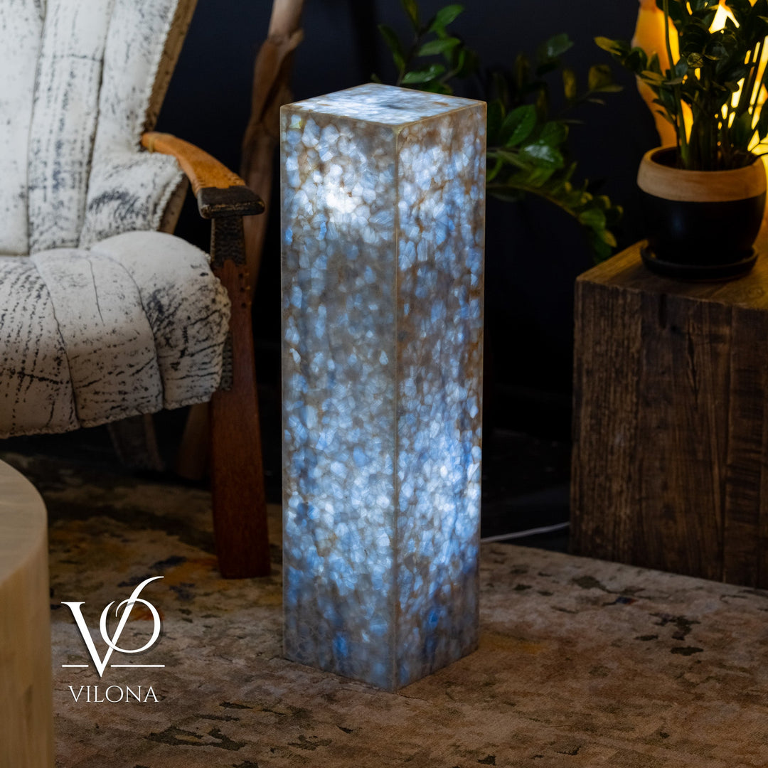 Blue square column floor lamp, full height view with glowing textured body.