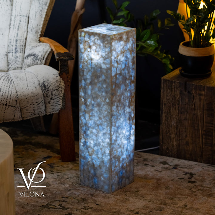 Blue square column floor lamp, full height view with glowing textured body.