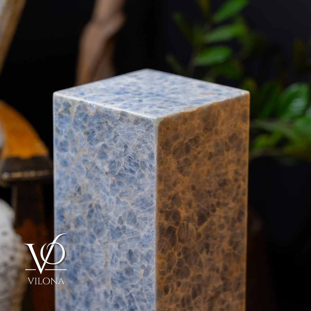 Blue square column floor lamp with warm-toned side panel and textured surface.