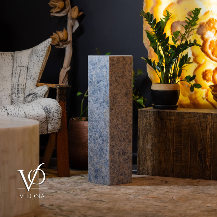 Blue square column floor lamp with soft glow through textured walls.