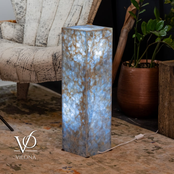 Small square blue stone floor lamp with bright glow through textured stone body