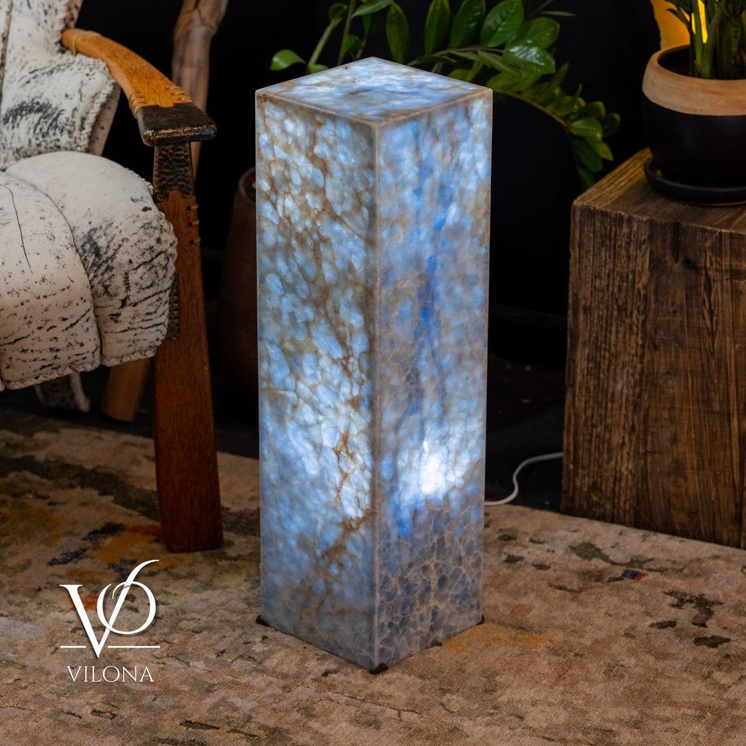 Small square blue stone floor lamp, illuminated pillar with textured surface detail