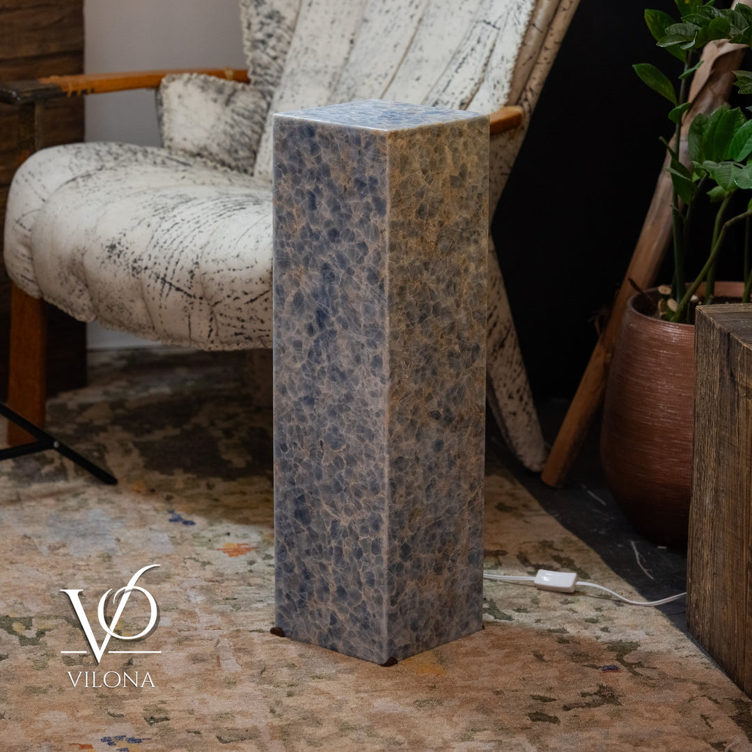 Small square blue stone floor lamp, angled view of textured blue-gray body