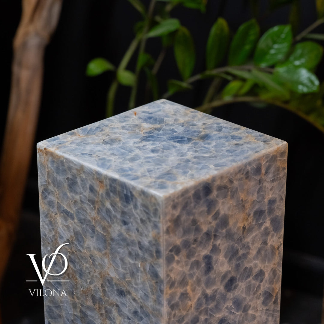 Small square blue stone floor lamp, close-up of top cap and textured illuminated surface