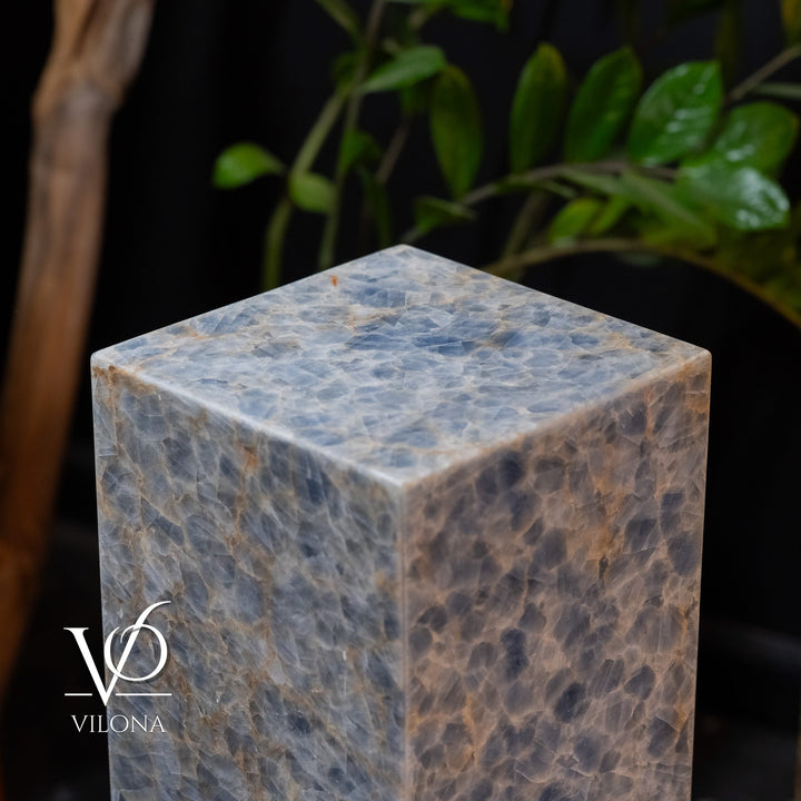 Small square blue stone floor lamp, close-up of top cap and textured illuminated surface