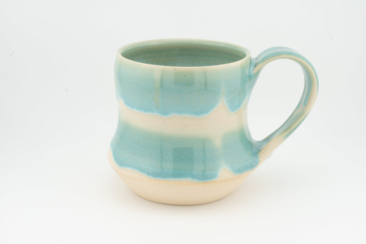Light turquoise speckled tall ceramic mug with curved handle