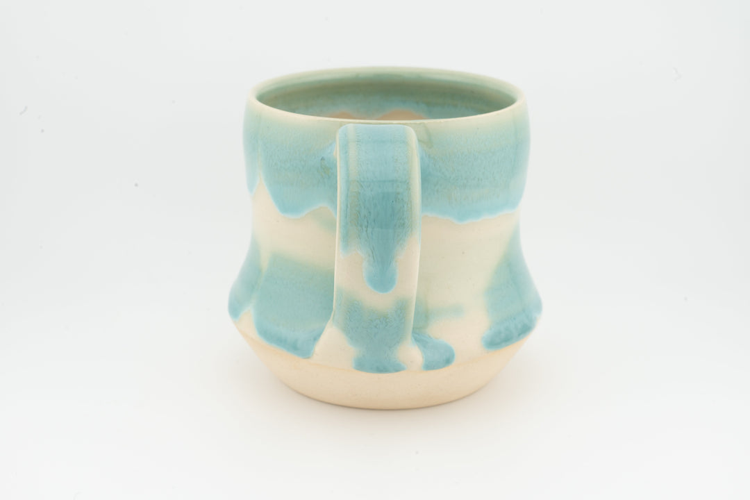 Turquoise ceramic tall mug with drip glaze and cream base