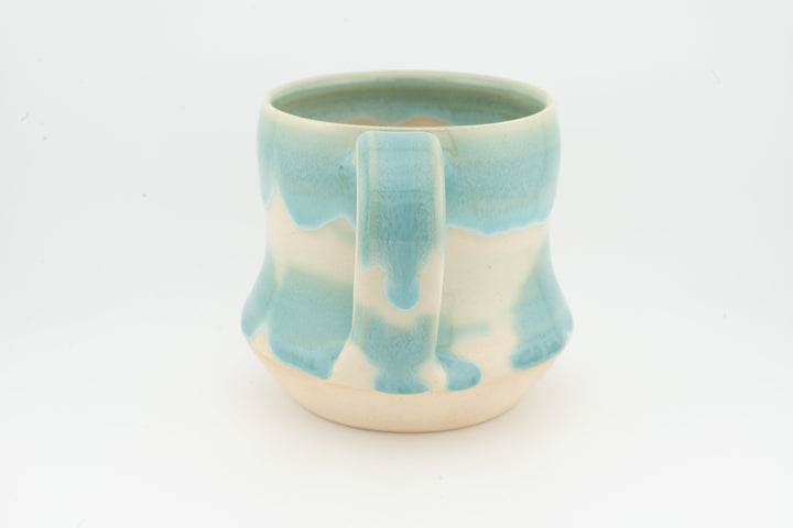 Turquoise ceramic tall mug with drip glaze and cream base