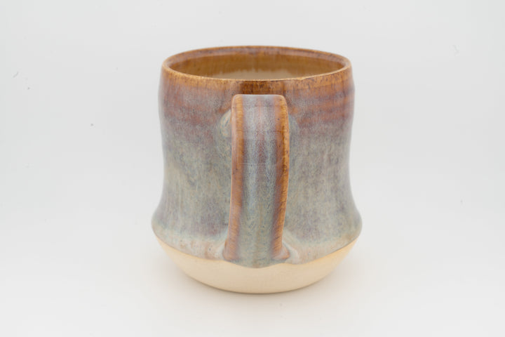 Tall ceramic mug with vertical drip stripe glaze and cream base