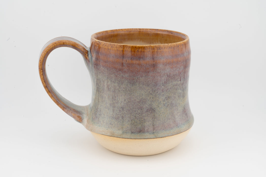 Tall ceramic mug with mottled gray-brown glaze and visible curved handle