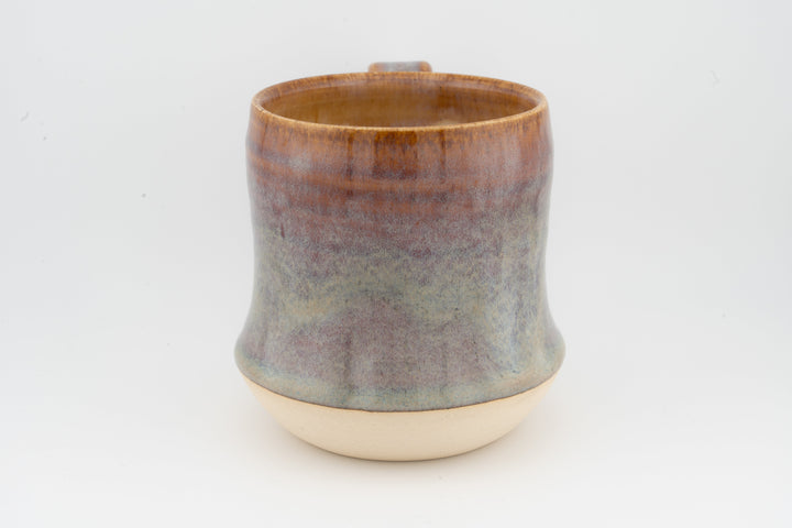 Tall ceramic mug with mottled gray-brown glaze and cream base