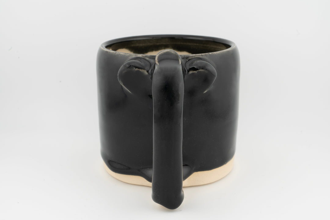 Ceramic mug with glossy black glaze and central drip-spout shape