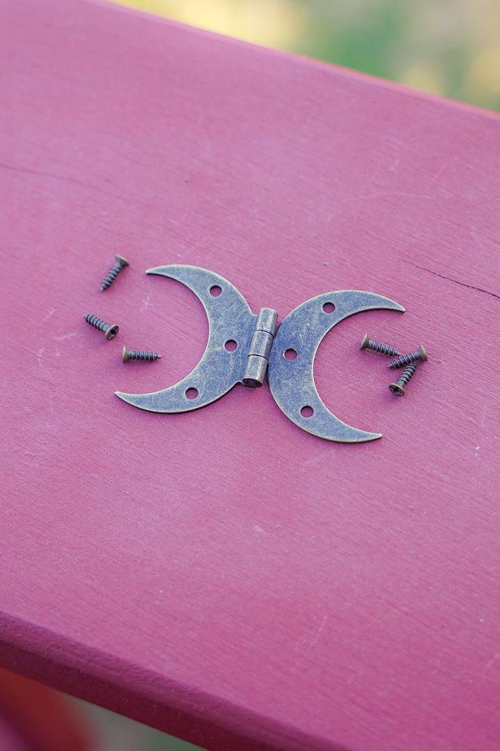 Steel crescent moon hinge pieces with screws, bronze finish on tabletop