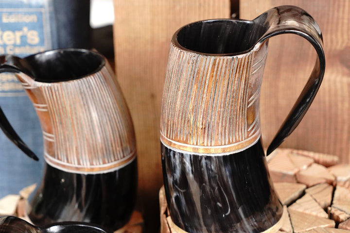 Two-tone horn stein with rounded handle, light vertical bands and dark lower body