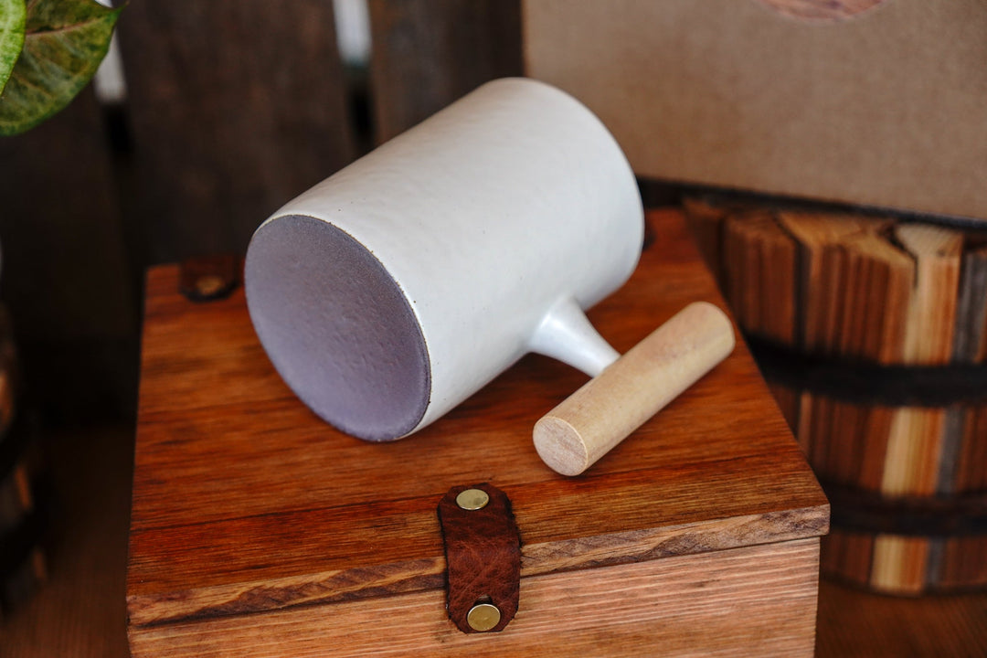 White ceramic mug with wooden handle, angled view