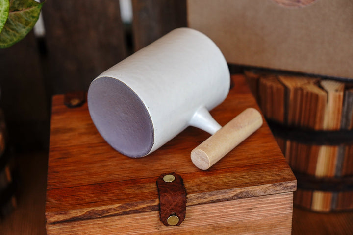 White ceramic mug with wooden handle, angled view