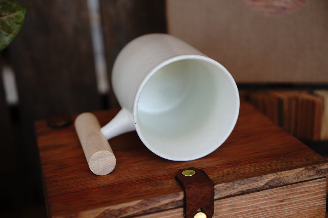 White ceramic mug with wooden handle, top view