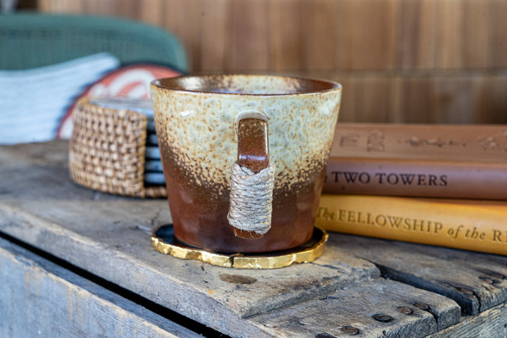 Stoneware coffee mug with mottled speckled glaze and wrapped handle