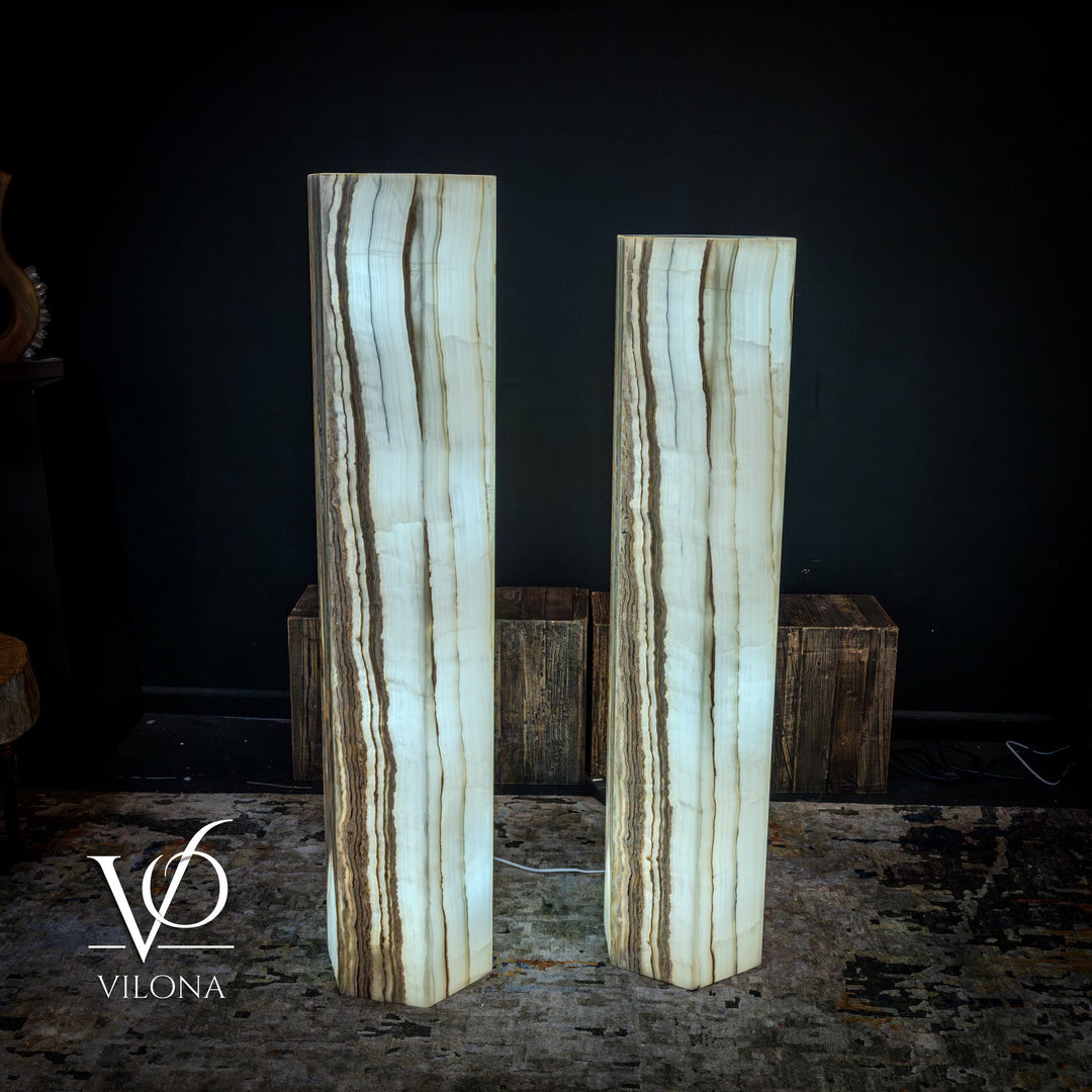 Pair of floor lamps with pale blue-white onyx columns and warm vertical streak highlights