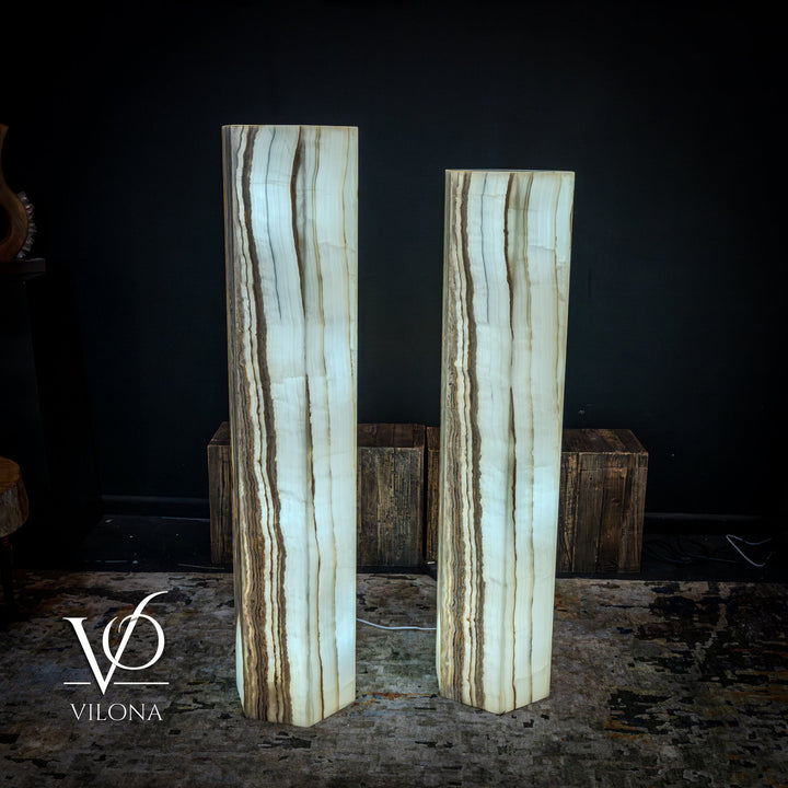 Pair of floor lamps with pale blue-white onyx columns and warm vertical streak highlights