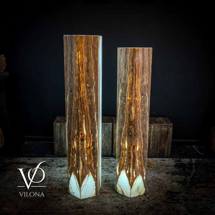 Pair of tall floor lamps with white and amber onyx stone shades and glowing bases