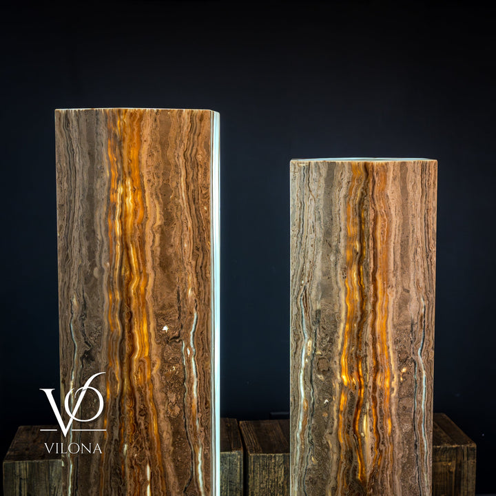 Pair of floor lamps with tall amber onyx shades and bright vertical light channels