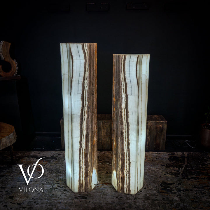 Pair of floor lamps featuring white onyx columns with vertical light-catching veining