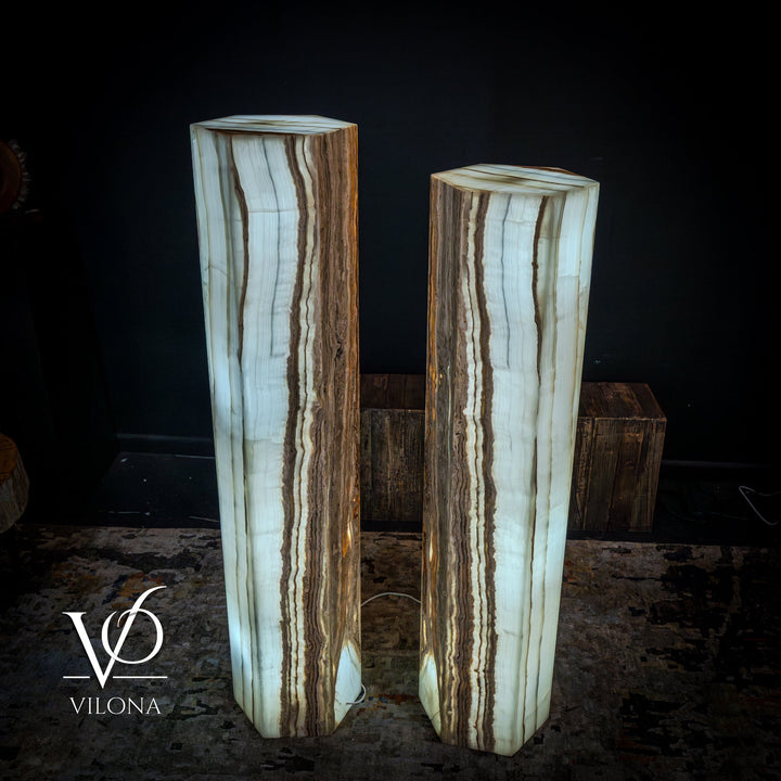 Pair of floor lamps with pale white onyx shades showing thin vertical brown streaks