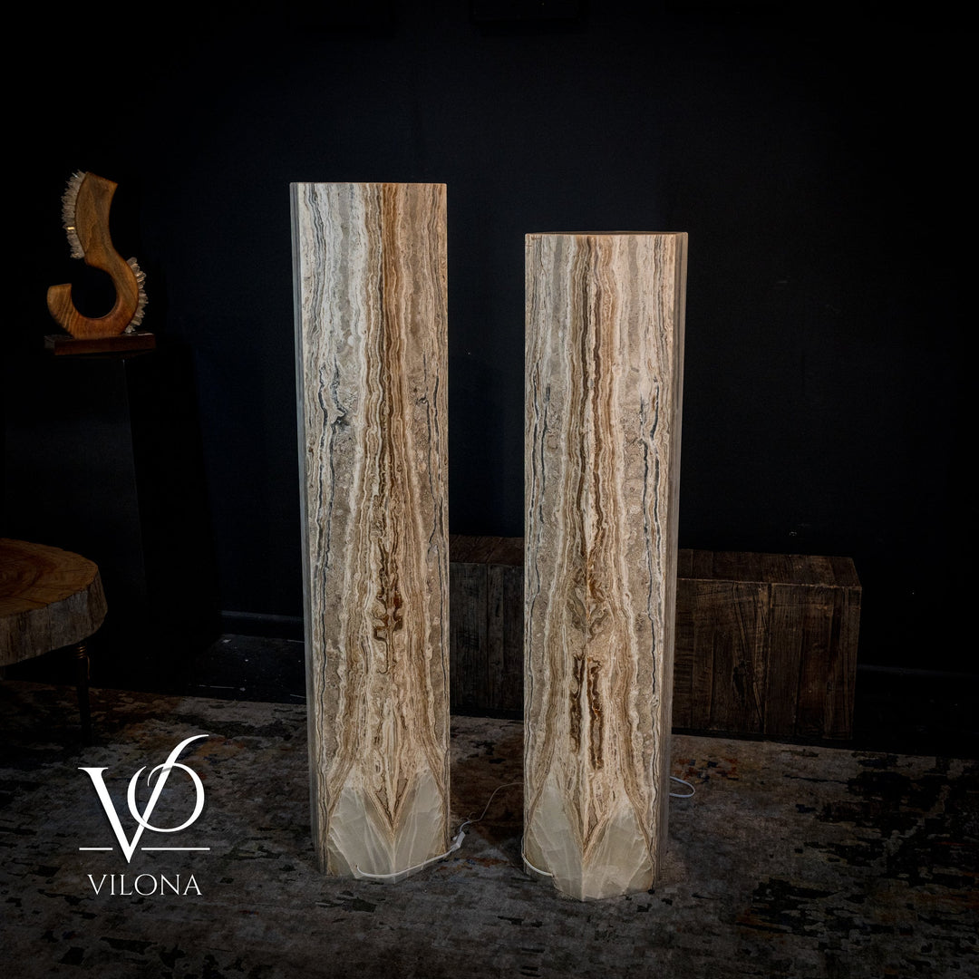 Pair of tall onyx floor lamps in cream and light brown with glowing vertical channels