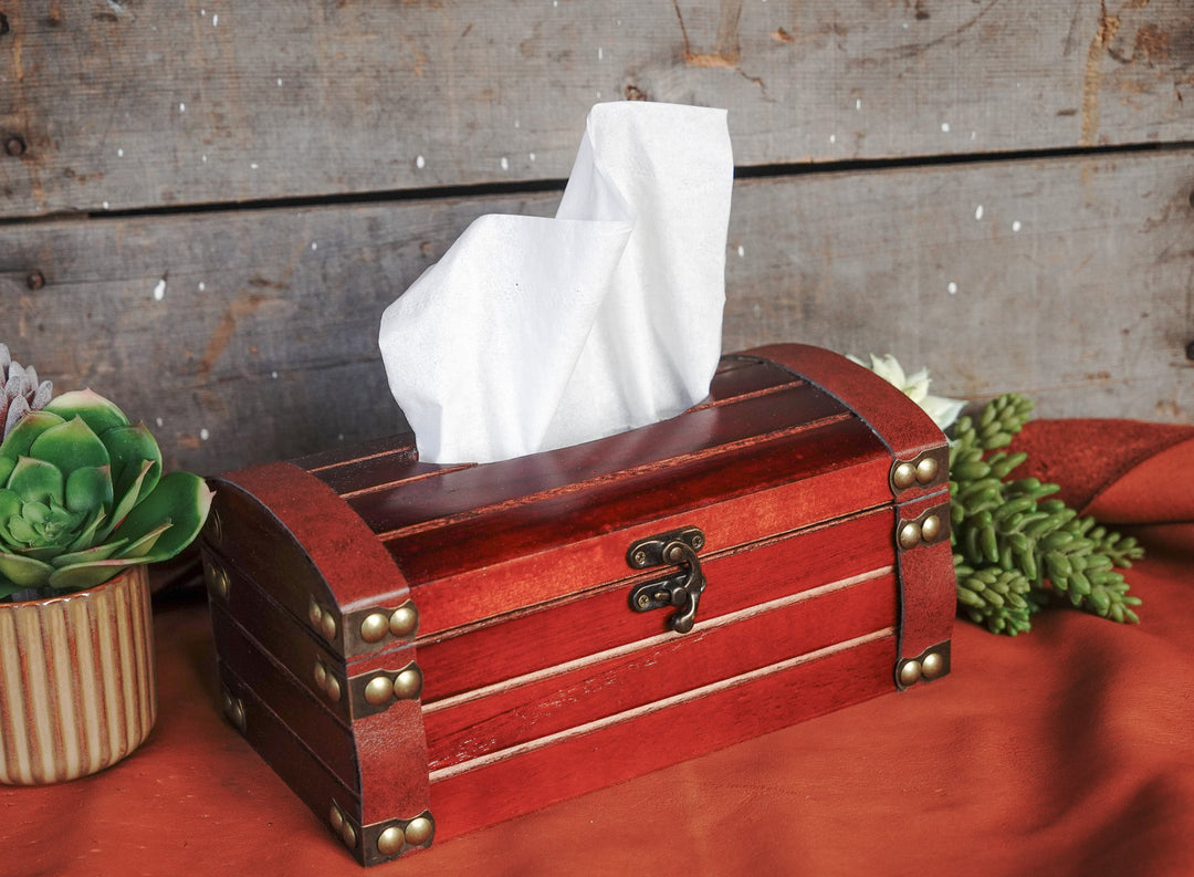 Red wooden tissue box with bronze studs and hinged lid, white tissue on top