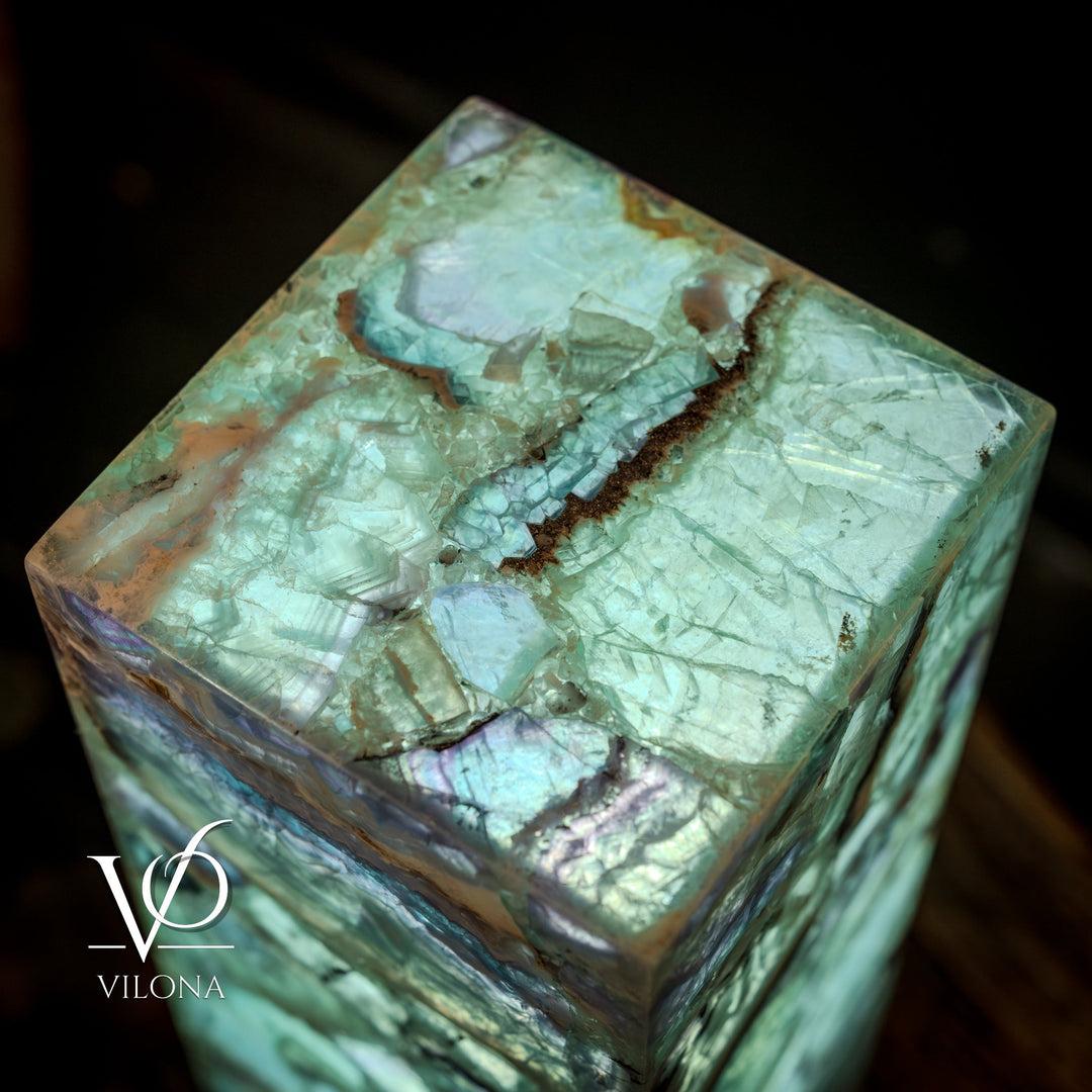 Fluorite crystal table lamp close-up of square top with teal-green glow and rough edges