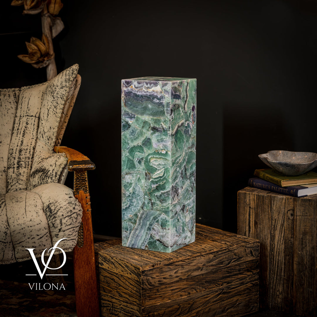 Green-blue fluorite crystal table lamp with square closed top on wooden surface