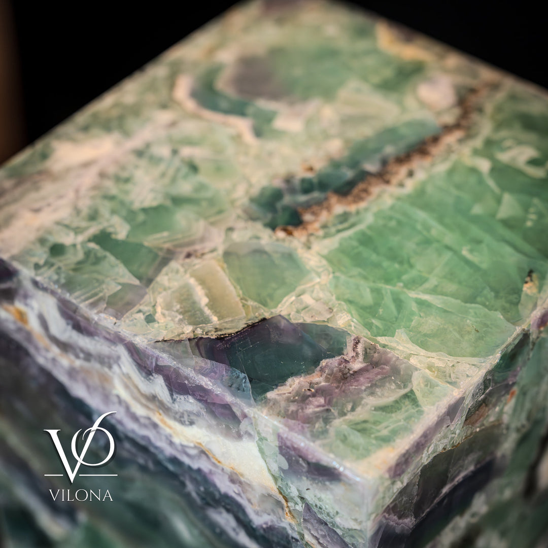 Teal green fluorite crystal lamp top close-up, faceted stone surface