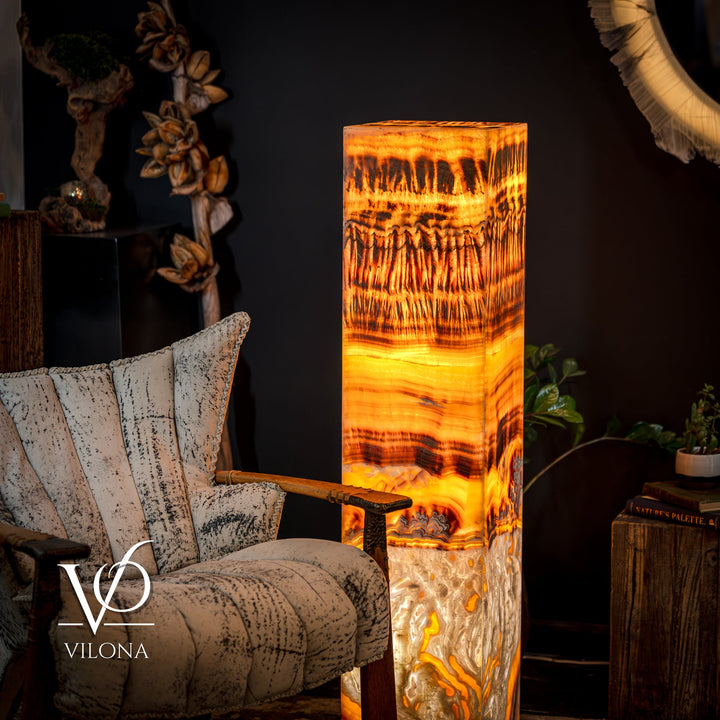 Onyx floor lamp side view with glowing square shade in golden orange and smoky dark lines