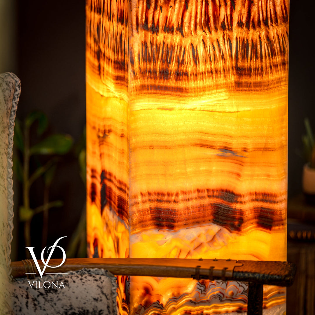 Onyx floor lamp lower section with warm golden glow and white marble-like texture
