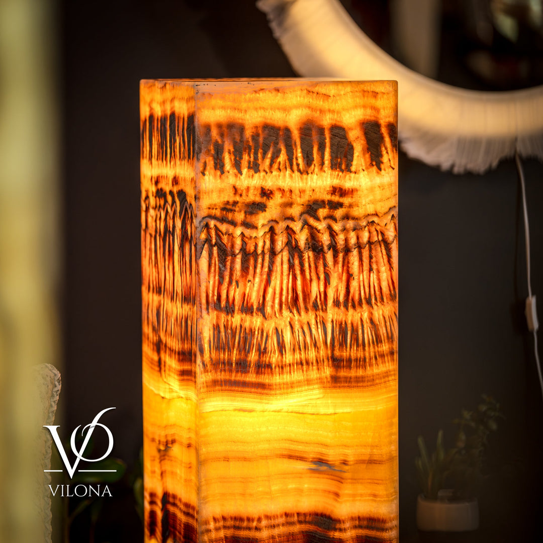 Onyx floor lamp close-up: glowing square shade with golden orange layered design