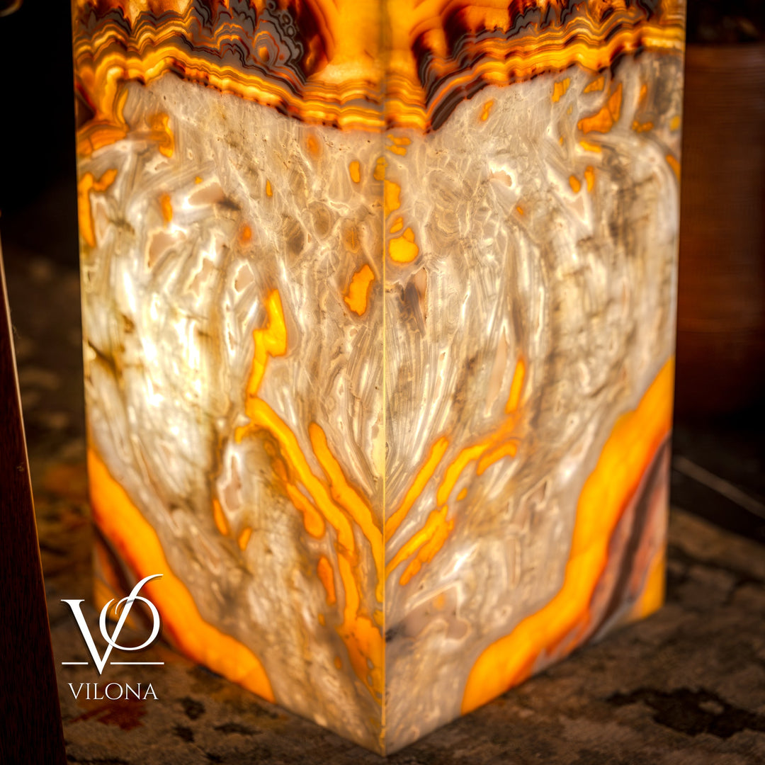 Onyx floor lamp base detail with white, amber swirls and bright orange glow