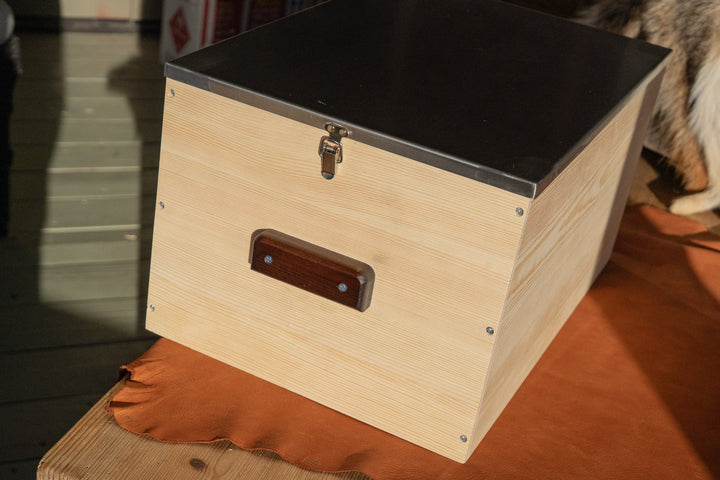 Light wood storage box with dark lid top and latching hardware, side view