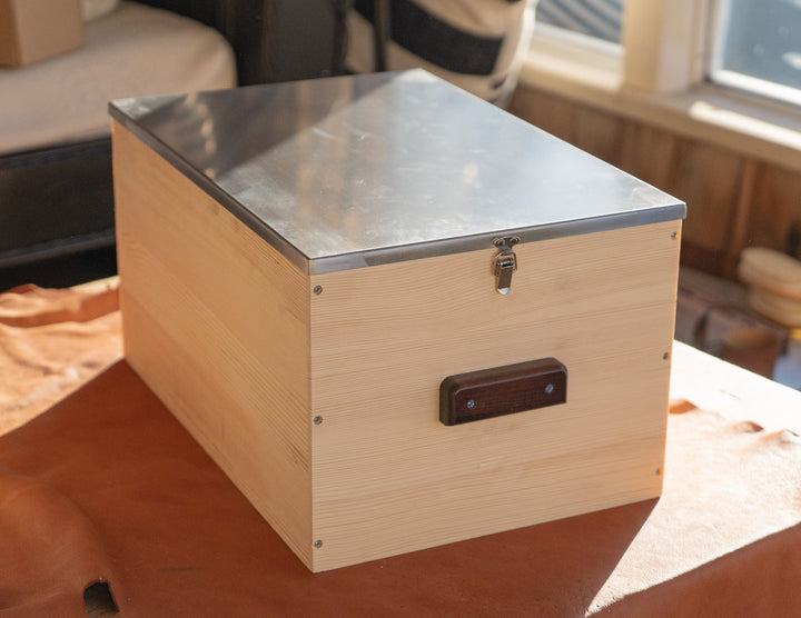 Light wood storage box with raised stainless steel lid and latching hardware