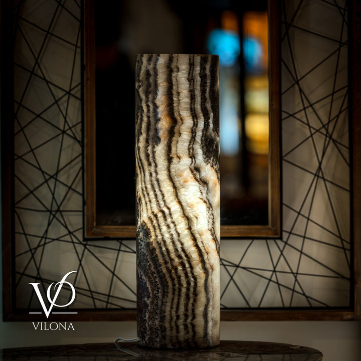 Onyx table lamp base featuring vertical ripple-like stripes in cream and dark tones.
