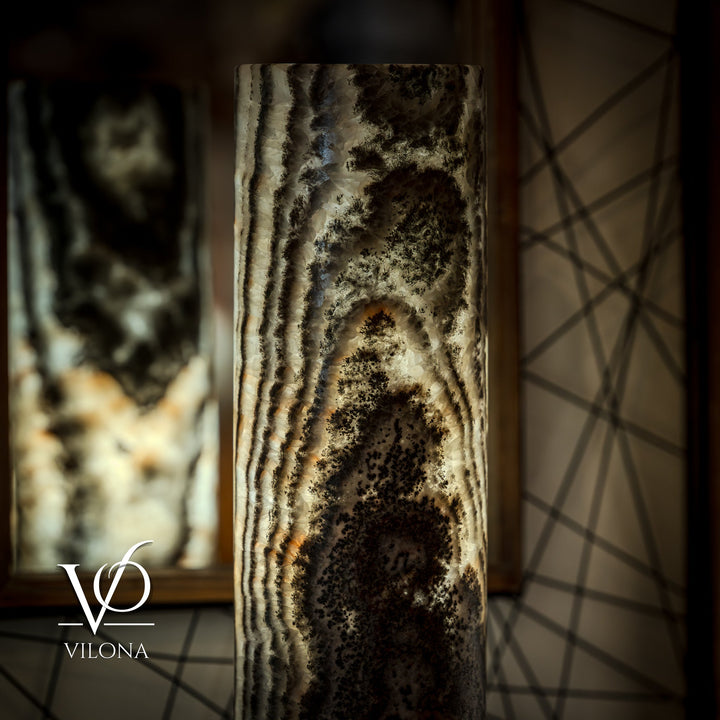 Close view of onyx table lamp base texture with dark bands and creamy highlights.