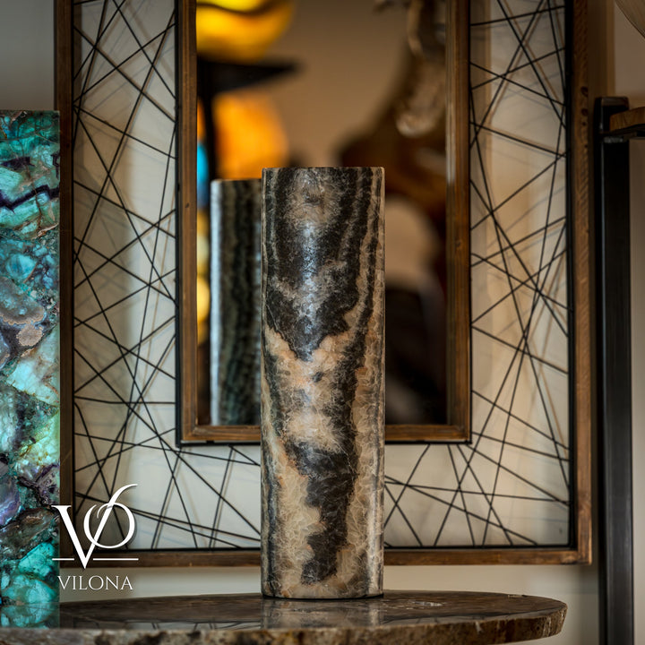Cylindrical onyx table lamp base, dark gray top with cream veining; visible cord.