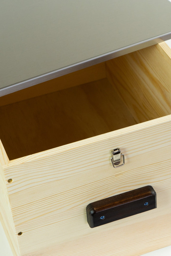 Open light wood storage box interior with latch and handle hardware
