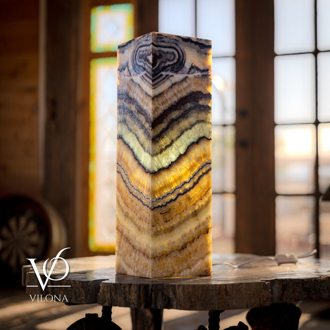 Square table lamp with onyx-style square shade, glowing, with layered zigzag stone lines