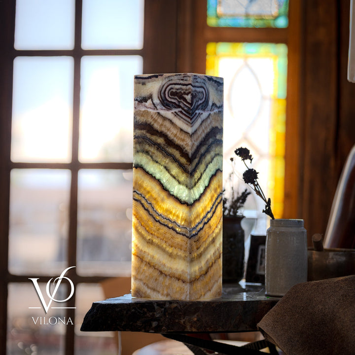 Square table lamp with lit onyx-style square shade showing blue and golden stone bands
